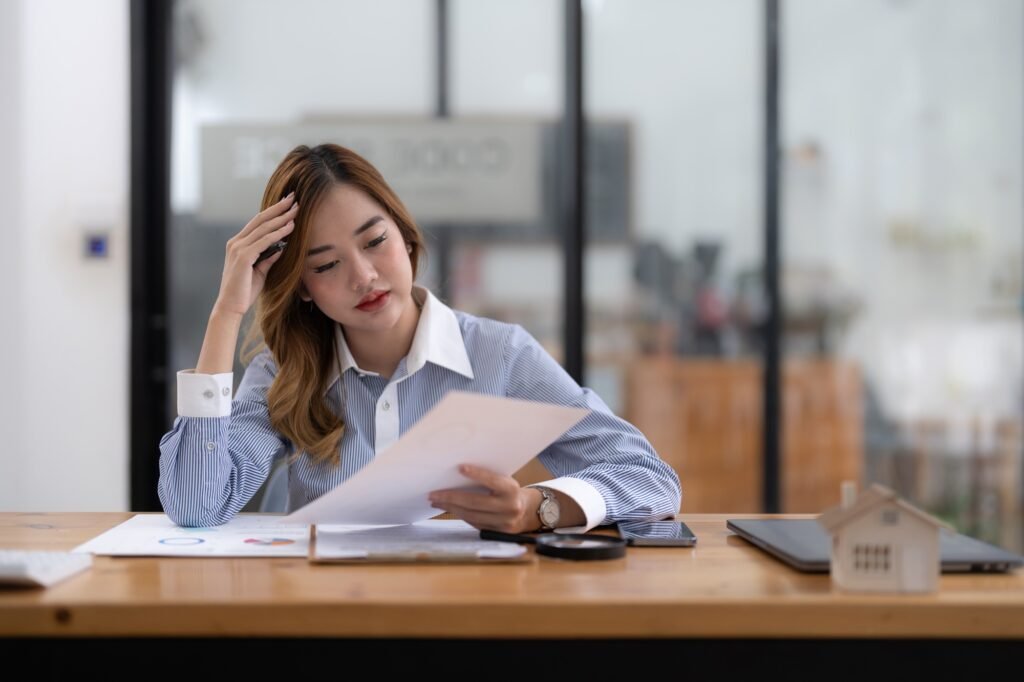 Asian investor businesswoman getting stressed about real estate finance.