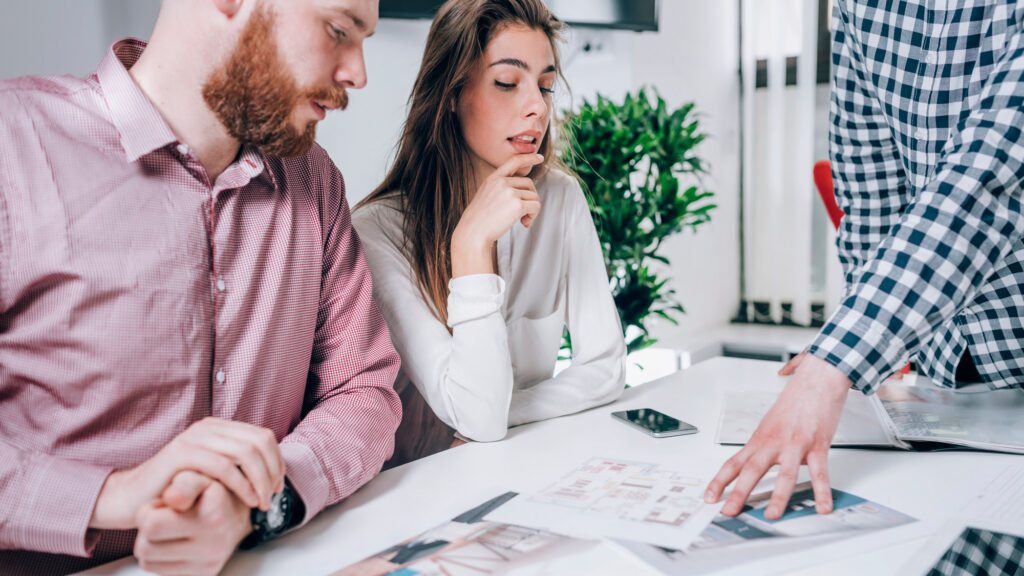 Couple in Real-Estate Agency Talking to Real Estate Agent