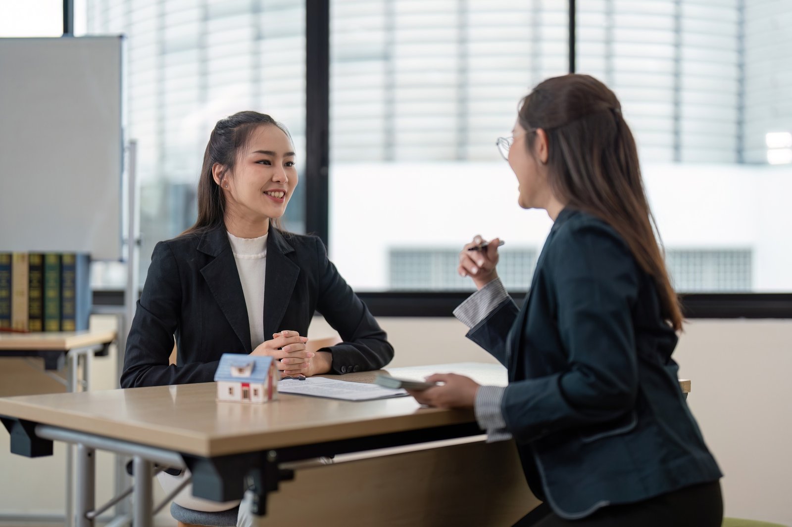 Professional Real Estate Agent Consulting with Client in Modern Office Setting